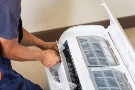technician preparing to install an air conditioner